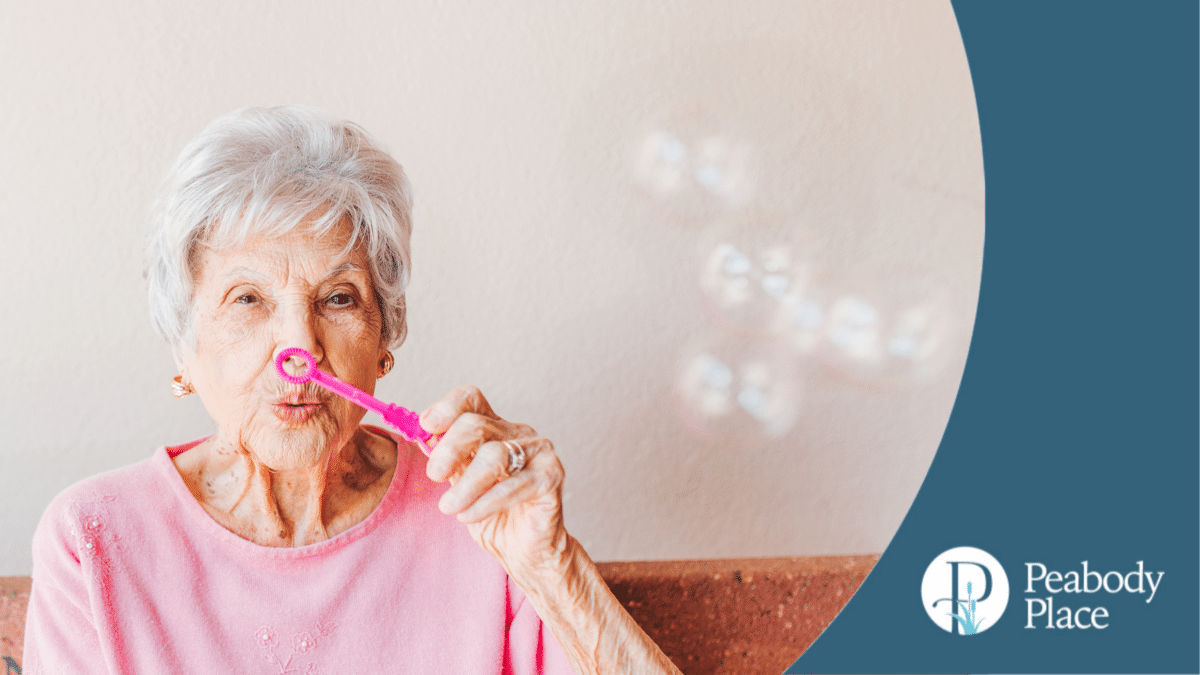 senior woman blowing bubbles long-term care model