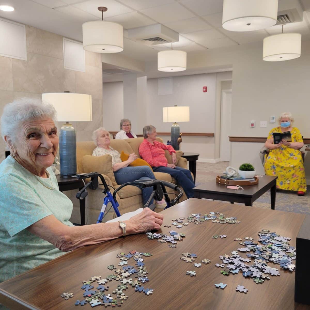 senior woman putting a puzzel together in a senior hall