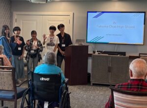Japanese students in front of a presentation